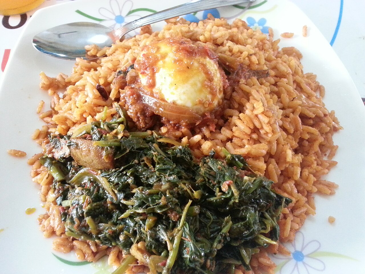 Jollof rice with vegetables and egg — a smaller portion alongside extra vegetables is a good balanced option
