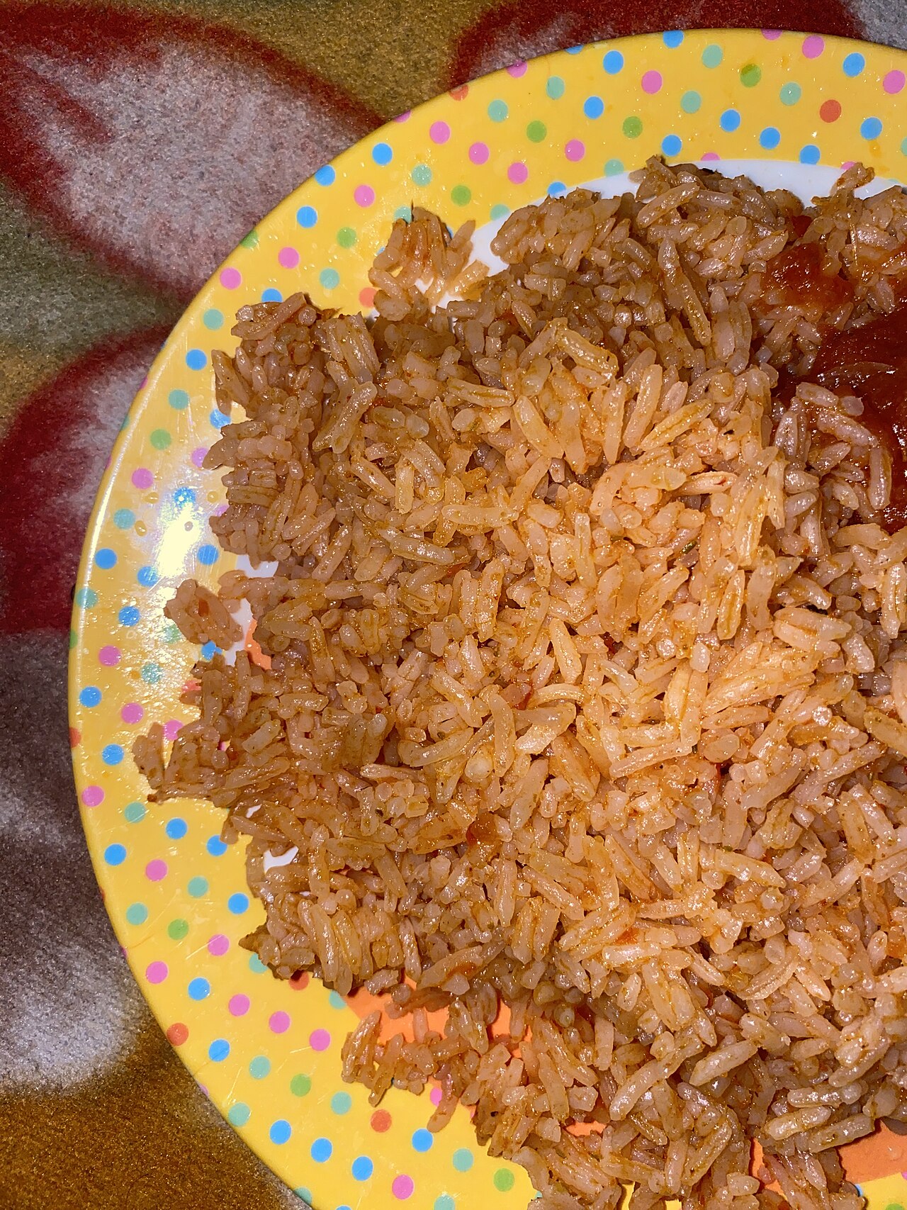Jollof rice with tomato stew — a familiar Nigerian meal that works well in smaller portions on treatment